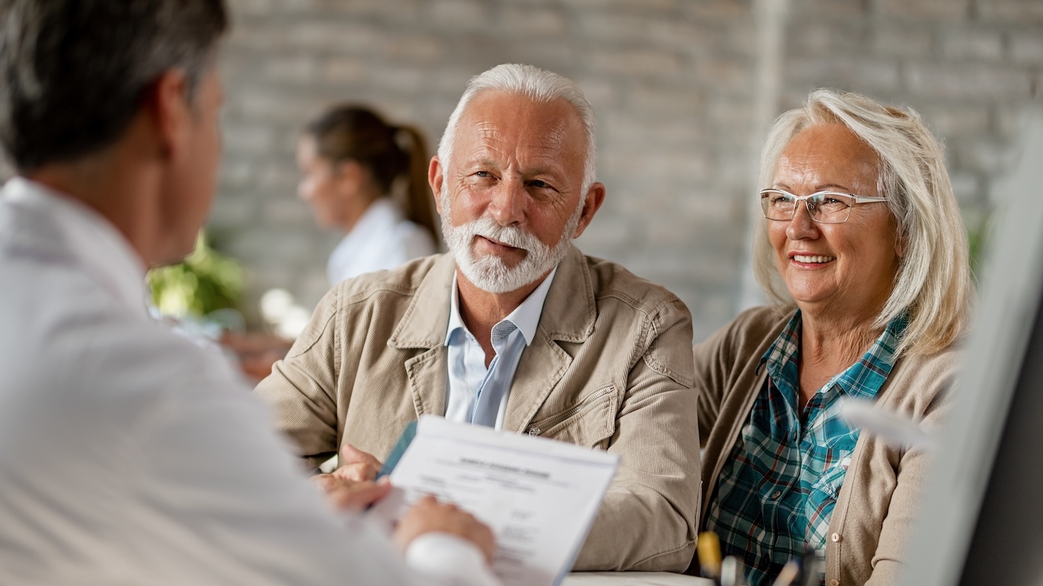 man and woman reviewing documents with an agent